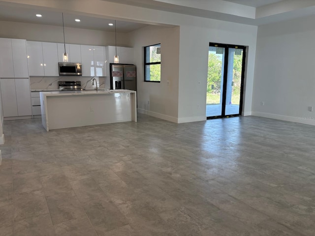 9 Tee View Rd, Rotonda West, FL 33947 - kitchen featuring appliances with stainless steel finishes, a sink, baseboards, open floor plan, and recessed lighting