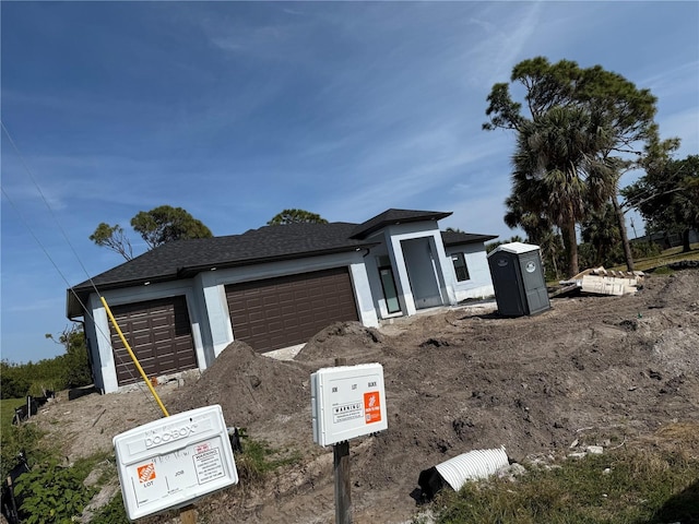 9 Tee View Rd, Rotonda West, FL 33947 - view of front facade with a garage and stucco siding