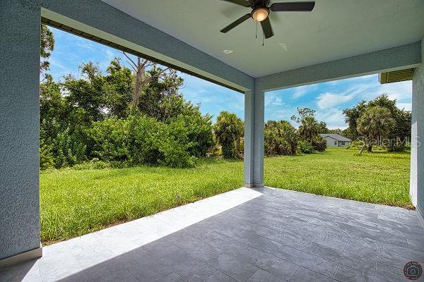 9 Tee View Rd, Rotonda West, FL 33947 - view of patio / terrace featuring a ceiling fan and view of wooded area