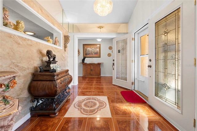 interior space with baseboards and an inviting chandelier