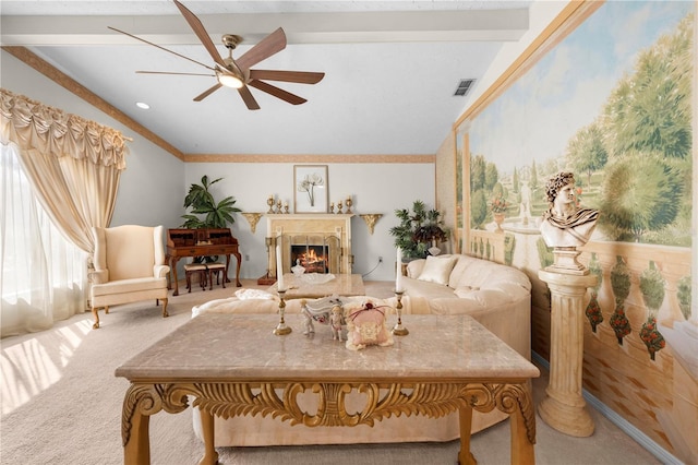 sitting room with a warm lit fireplace, carpet floors, ceiling fan, and visible vents