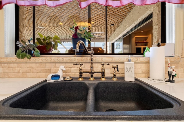 room details featuring tasteful backsplash and a sink