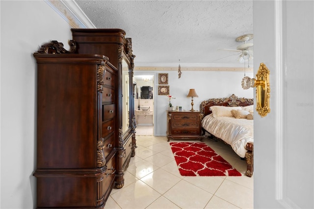 bedroom featuring light tile patterned floors, ornamental molding, and a textured ceiling