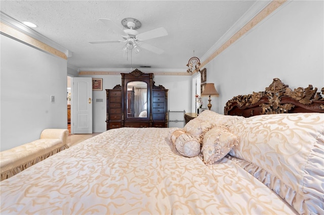 bedroom featuring ceiling fan, ornamental molding, and a textured ceiling