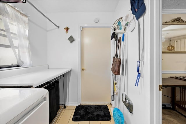 kitchen with light countertops, light tile patterned flooring, and separate washer and dryer