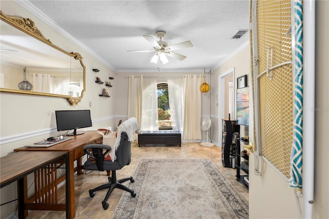 office with a textured ceiling, ceiling fan, visible vents, and crown molding