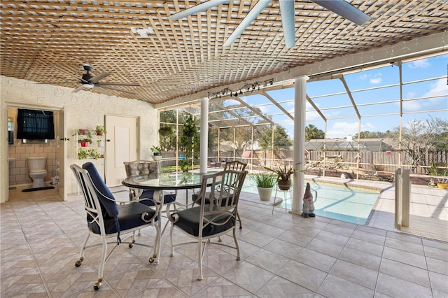 unfurnished sunroom featuring ceiling fan