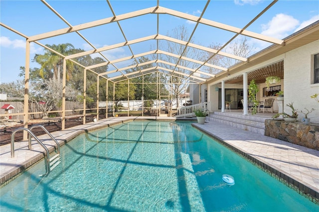 view of swimming pool with a fenced in pool, fence private yard, glass enclosure, and a patio area