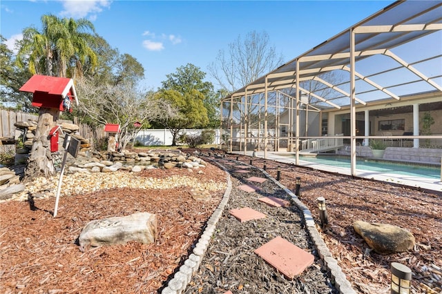 view of yard with a fenced in pool, a lanai, and fence