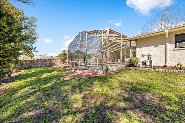 view of yard featuring a fenced in pool, glass enclosure, a fenced backyard, and a patio