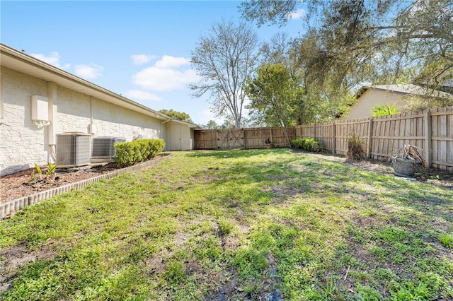 view of yard featuring a fenced backyard and central AC unit