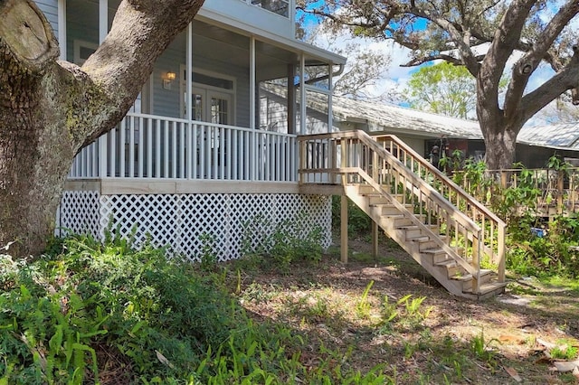 view of home's exterior with covered porch and stairway