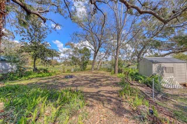 view of yard featuring a shed and an outdoor structure