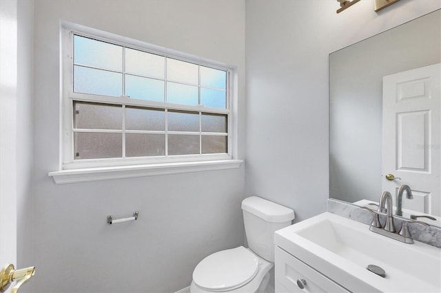 half bathroom featuring toilet and vanity