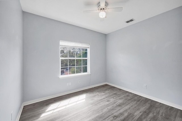 unfurnished room with visible vents, ceiling fan, baseboards, and wood finished floors