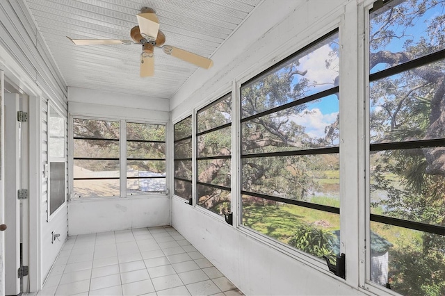 unfurnished sunroom featuring ceiling fan