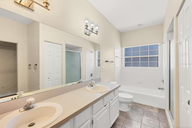 bathroom with a closet, a sink, toilet, and tile patterned floors