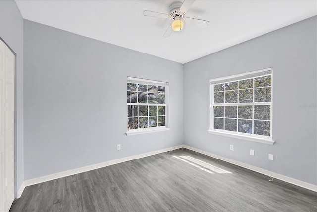 spare room with ceiling fan, baseboards, and wood finished floors