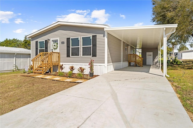 manufactured / mobile home with driveway and an attached carport