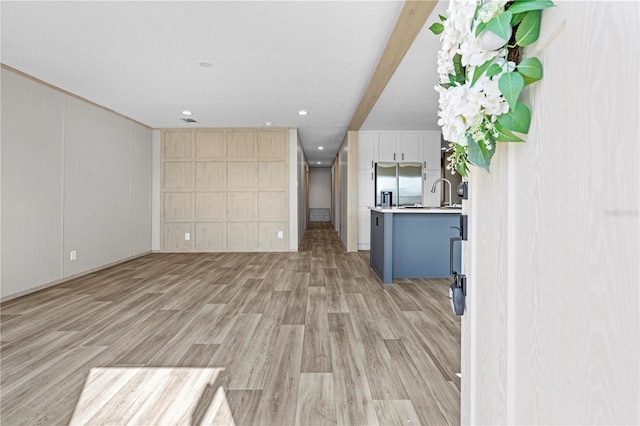 unfurnished living room with light wood-type flooring, visible vents, and recessed lighting