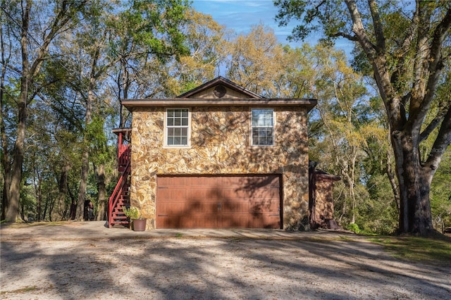 view of home's exterior featuring stone siding and stairway