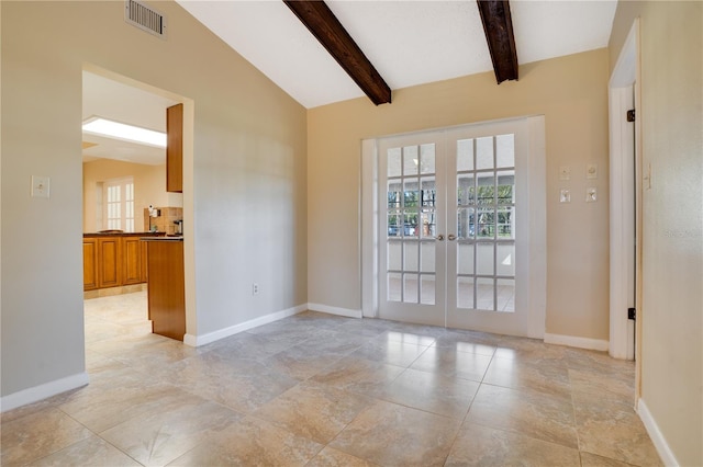 spare room featuring lofted ceiling with beams, baseboards, visible vents, and french doors