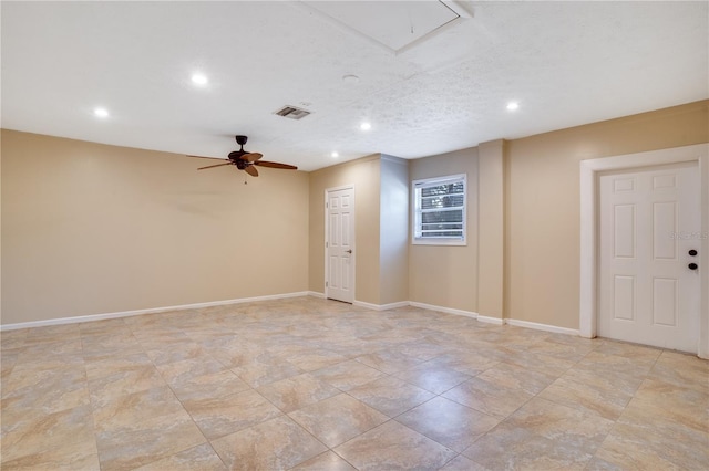 unfurnished room featuring attic access, visible vents, baseboards, and recessed lighting