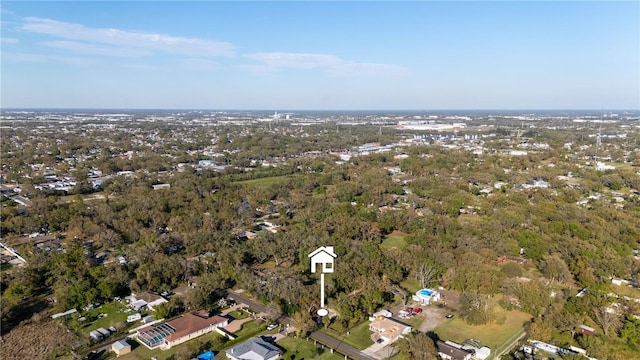 bird's eye view with a wooded view