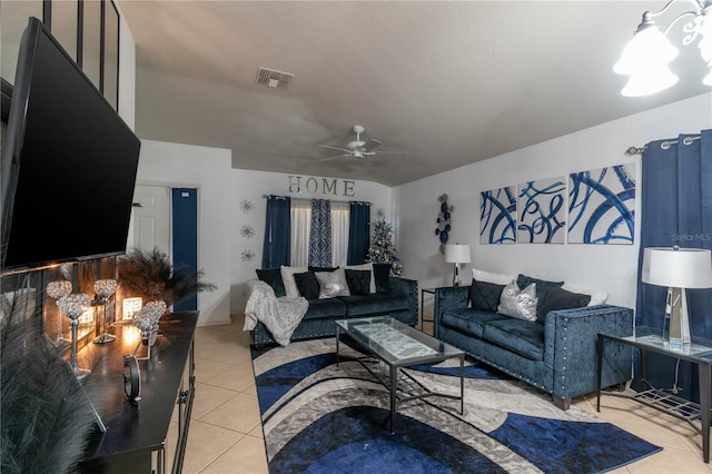 living room featuring light tile patterned floors, visible vents, and a ceiling fan