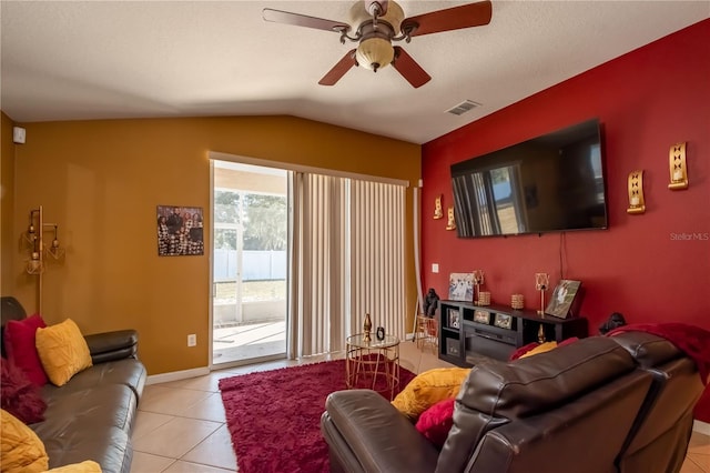 living area with light tile patterned floors, baseboards, visible vents, a ceiling fan, and lofted ceiling