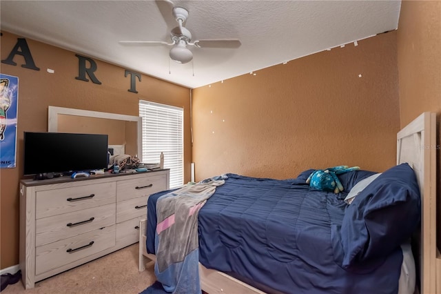 bedroom featuring a textured ceiling, a textured wall, and a ceiling fan