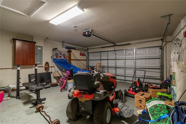 garage with electric panel, concrete block wall, and a garage door opener