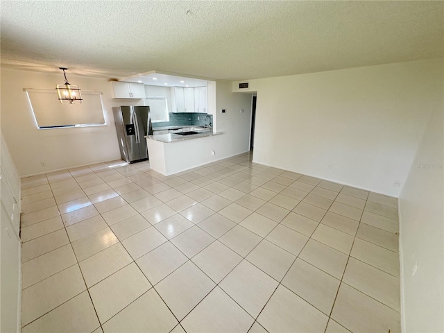 3300 Fox Chase Cir N Unit 229, Palm Harbor, FL 34683 - unfurnished living room with light tile patterned floors and a textured ceiling