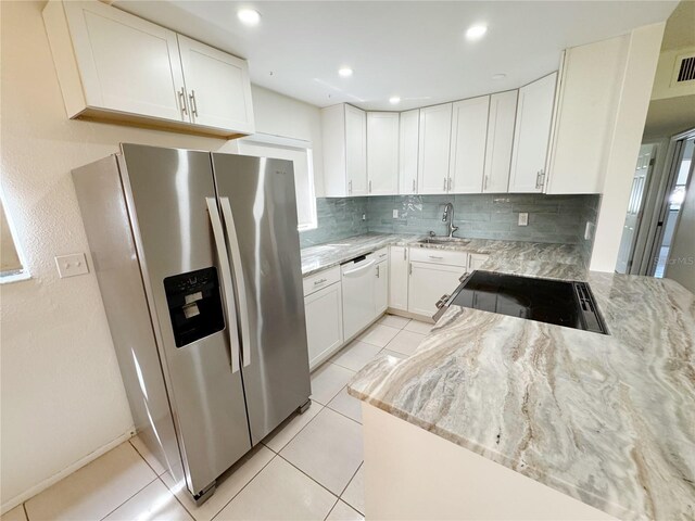 3300 Fox Chase Cir N Unit 229, Palm Harbor, FL 34683 - kitchen with stainless steel refrigerator with ice dispenser, dishwasher, a sink, light stone countertops, and recessed lighting