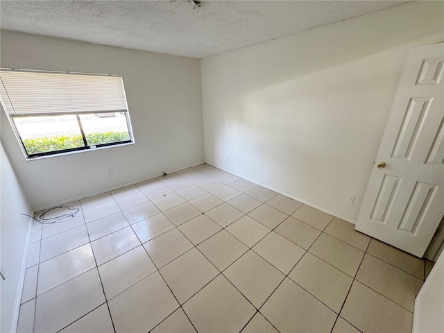3300 Fox Chase Cir N Unit 229, Palm Harbor, FL 34683 - spare room with light tile patterned floors and a textured ceiling