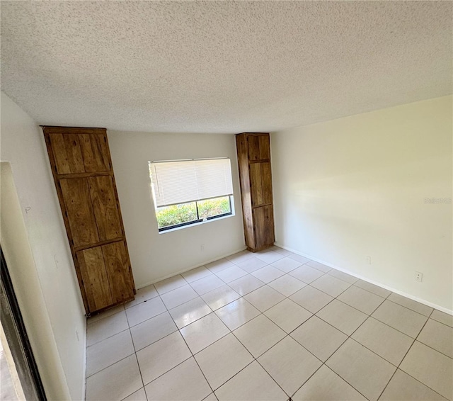 3300 Fox Chase Cir N Unit 229, Palm Harbor, FL 34683 - unfurnished room featuring light tile patterned floors and a textured ceiling