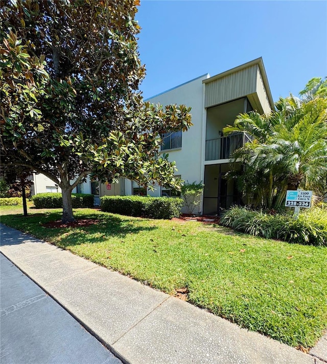 3300 Fox Chase Cir N Unit 229, Palm Harbor, FL 34683 - view of front of property featuring a front lawn