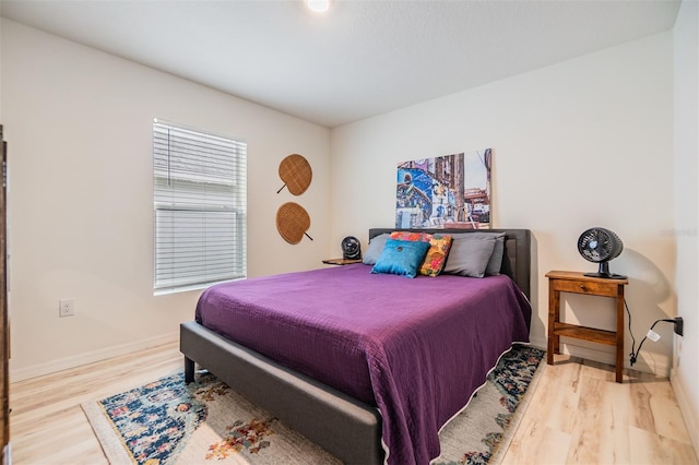 bedroom featuring baseboards and wood finished floors