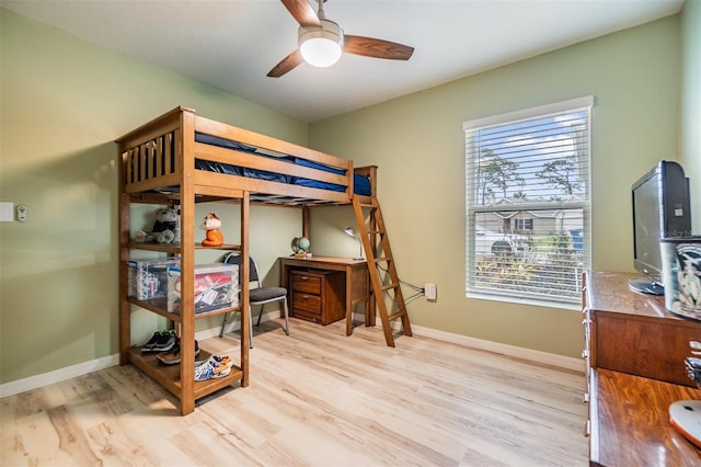 bedroom with light wood finished floors, ceiling fan, and baseboards