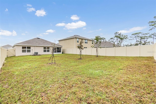 view of yard featuring a fenced backyard and central AC unit