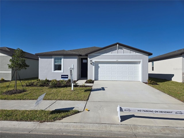 ranch-style house featuring a garage, a front yard, driveway, and stucco siding