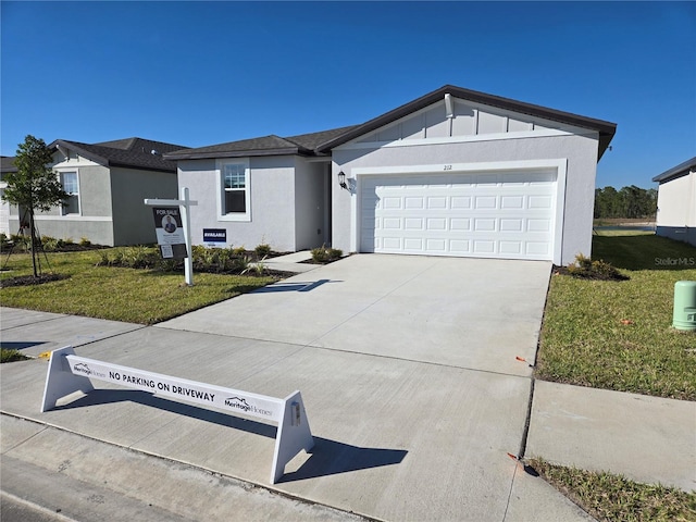 ranch-style home featuring concrete driveway, a front lawn, an attached garage, and stucco siding