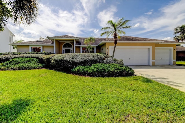 single story home featuring an attached garage, driveway, a front yard, and stucco siding