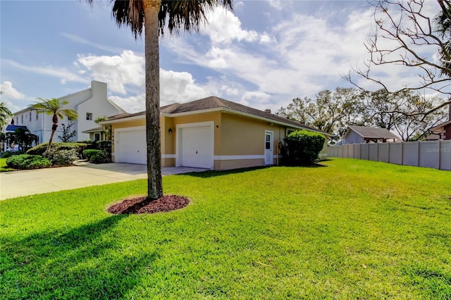 view of front facade featuring a garage, a front yard, fence, and stucco siding