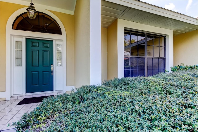 view of exterior entry featuring stucco siding