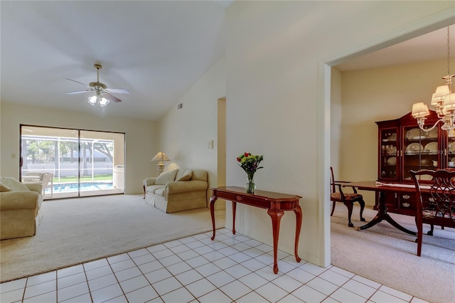 interior space featuring light carpet, light tile patterned floors, high vaulted ceiling, and ceiling fan with notable chandelier