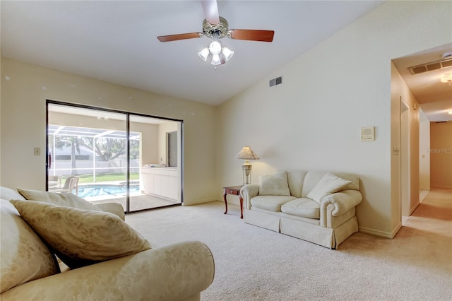 living room featuring light colored carpet, lofted ceiling, a sunroom, and visible vents