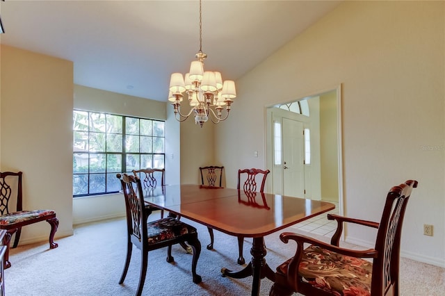 dining room with lofted ceiling, light colored carpet, baseboards, and an inviting chandelier