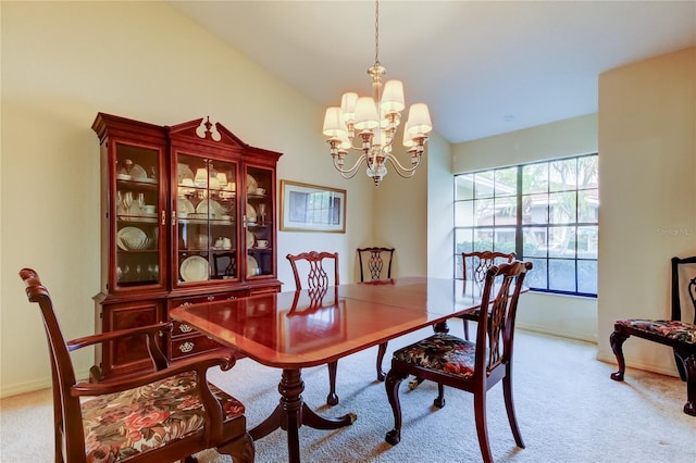 dining space featuring a chandelier, light carpet, and baseboards