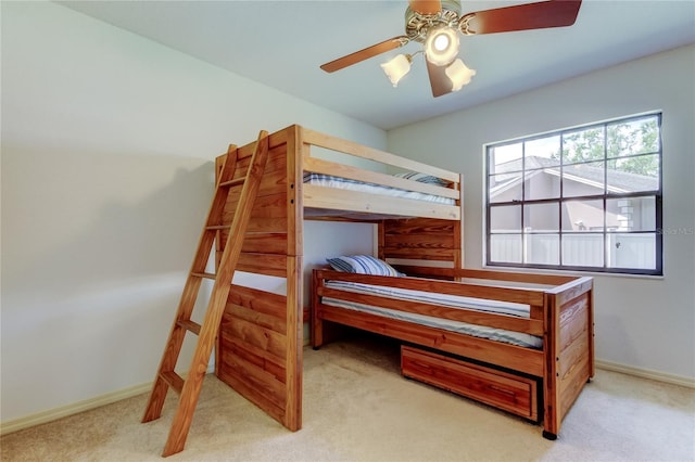 carpeted bedroom featuring ceiling fan and baseboards